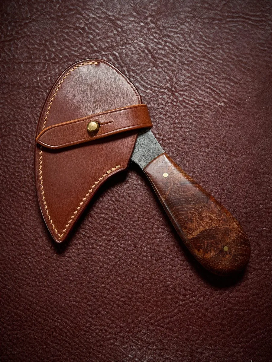 Étui en cuir brun à patte de fermeture et bouton en laiton, pour un couteau à manche en bois